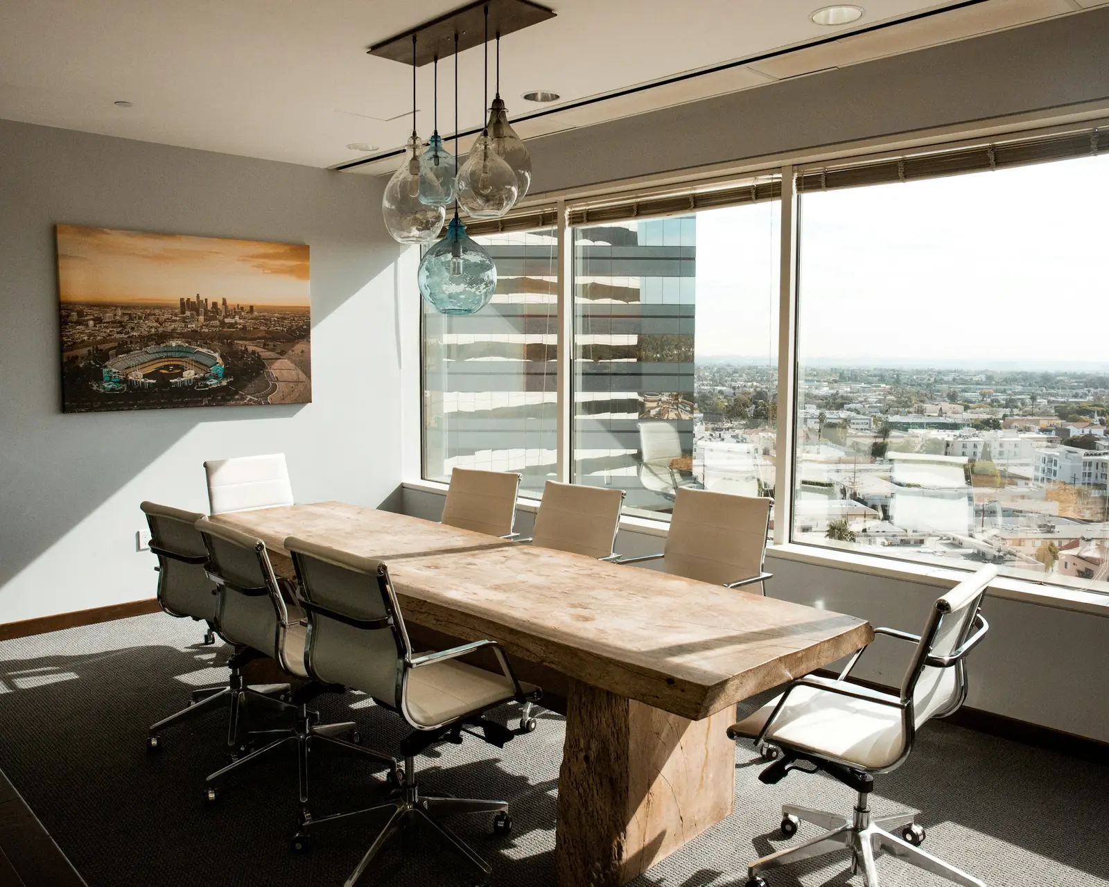 A conference room with a timber table and city views