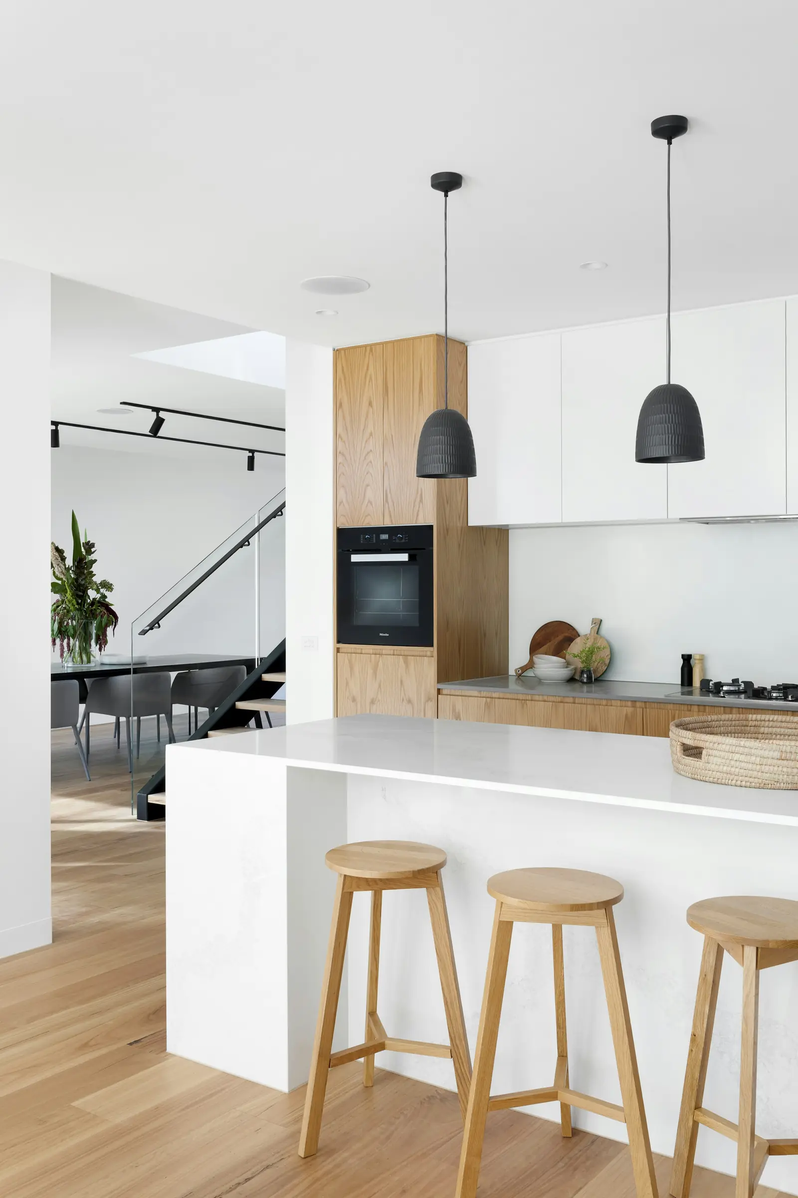 A modern kitchen with pendant lights and an island