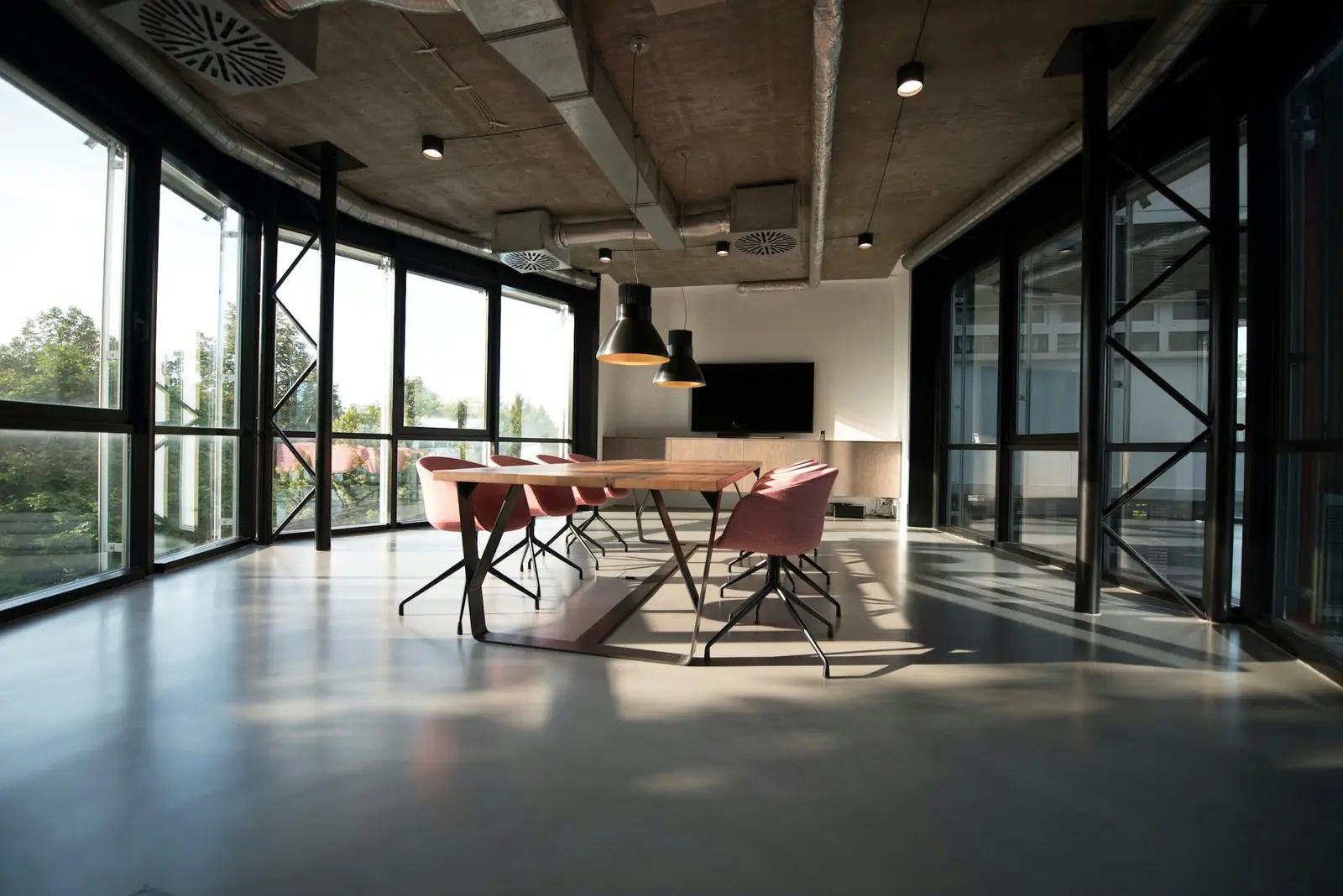 An open office with glass walls and long tables