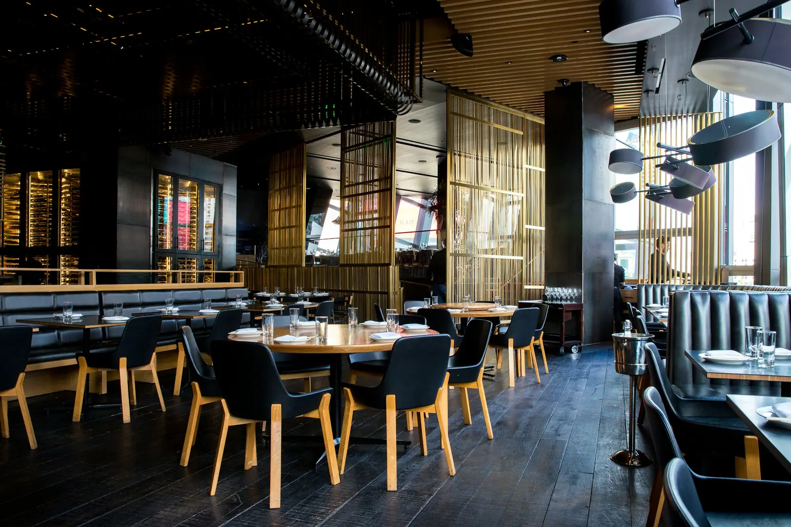 A dark, warmly lit restaurant dining room